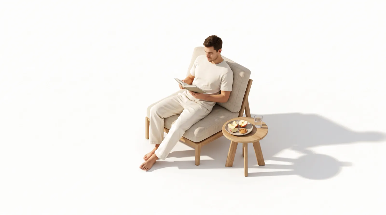 A man reading in an armchair with apple slices, peanut butter and water on a side table