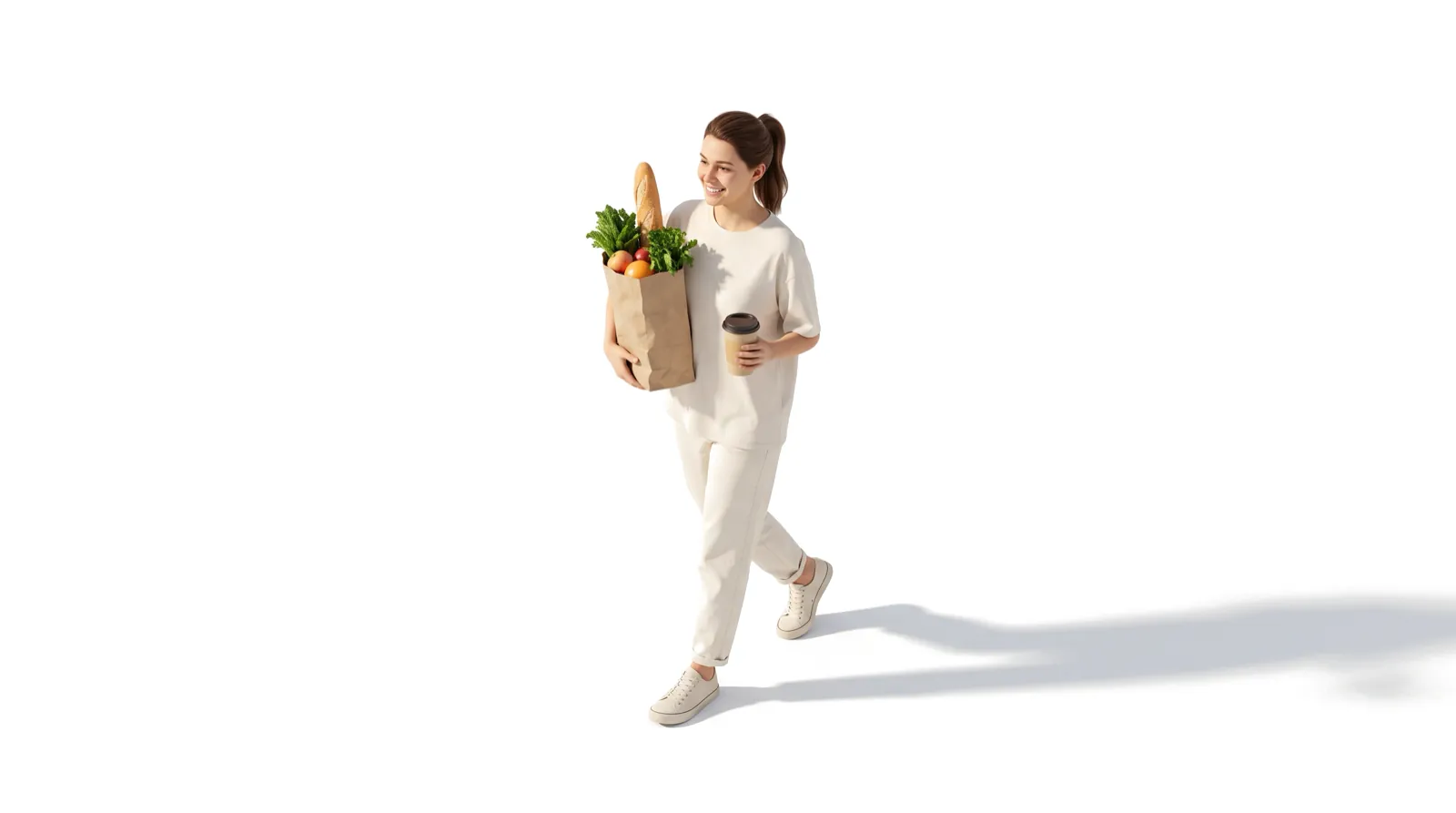 A smiling woman walking with a bag of groceries and a takeaway coffee